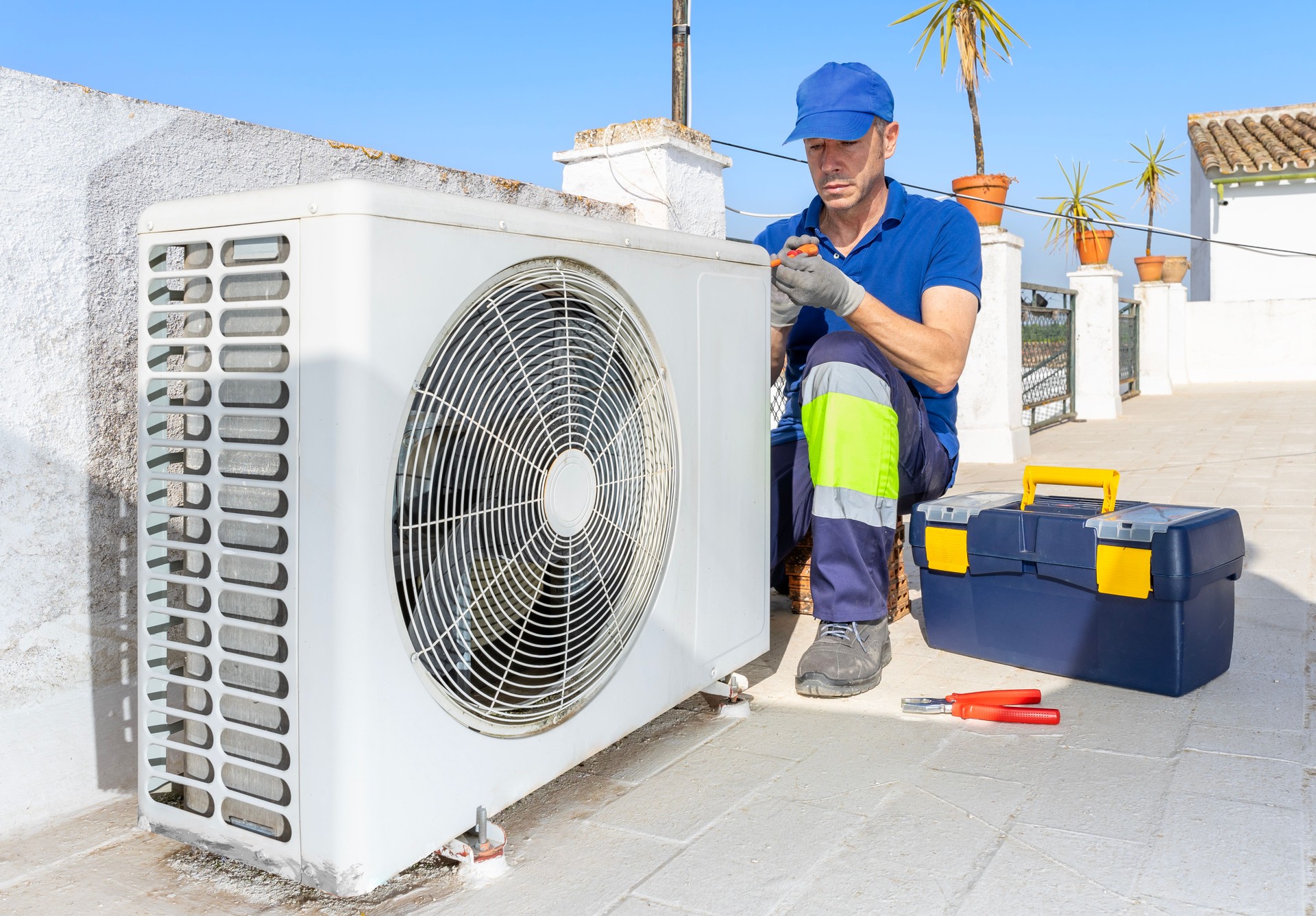 Hvac technician performing air conditioner repair service.